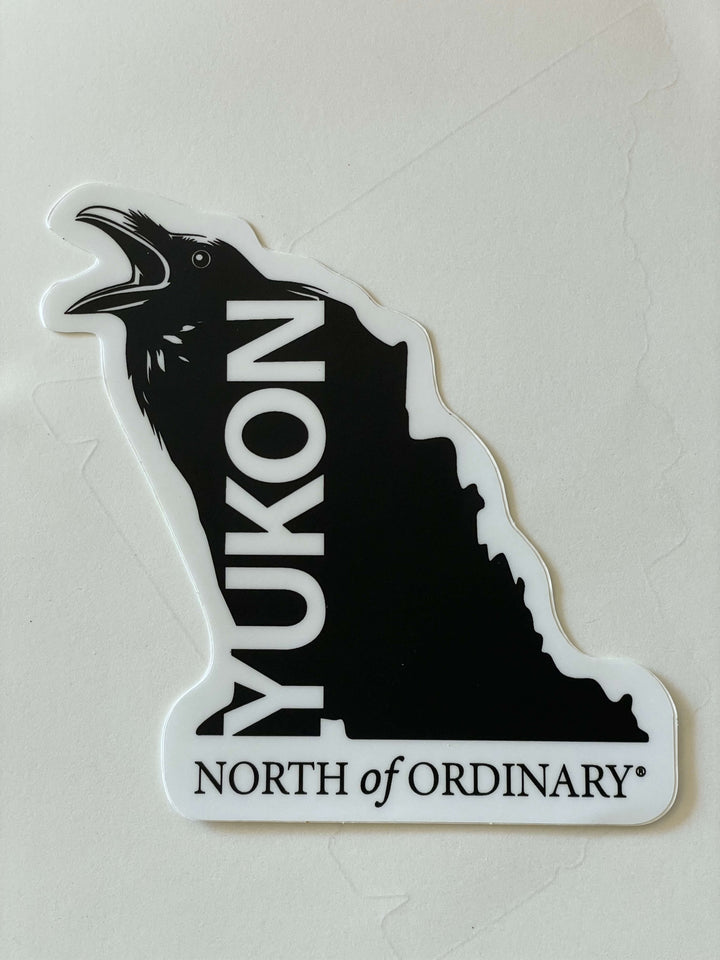Sticker with a silhouette of the Yukon and 'Yukon North of Ordinary' text on a light gray background