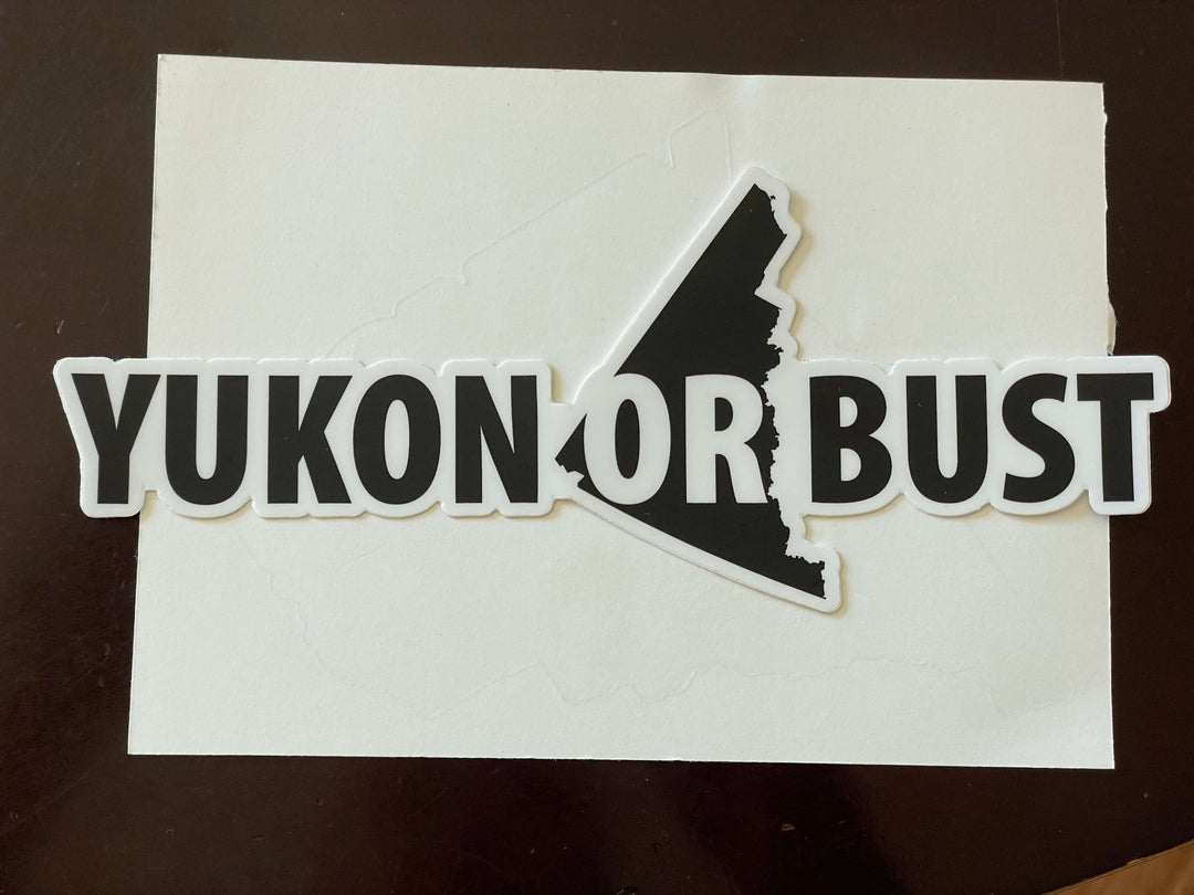 Decal with 'Yukon or Bust' text on a white background