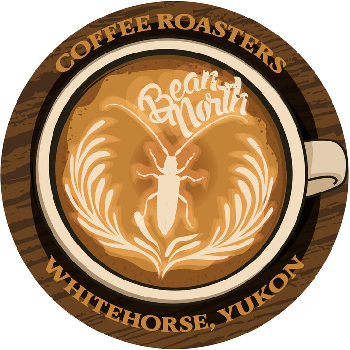 Logo of Bear North Coffee Roasters with a coffee cup design and text on a wooden background.